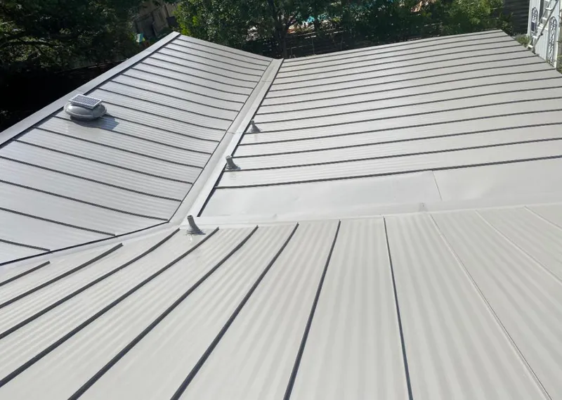 Solar attic fan installed on a metal roof for Roof Ventilation in Prairie Village